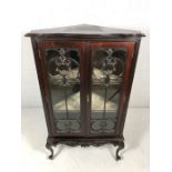 Dark wood corner display cabinet with two lined shelves on Queen Anne legs