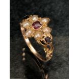 Antique gold ring of daisy design set with seed pearls and garnets, size approx N, no hallmarks