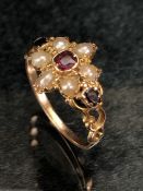 Antique gold ring of daisy design set with seed pearls and garnets, size approx N, no hallmarks