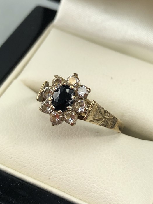 9ct Gold hallmarked Daisy ring set with an oval Sapphire and surrounded by eight Diamonds size 'N' - Image 2 of 5