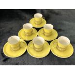 Set of six Shelley espresso cups and saucers in yellow with hallmarked silver holders