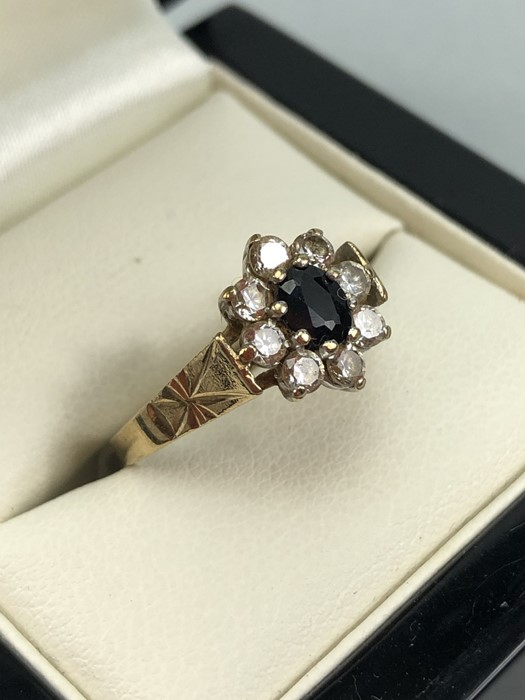 9ct Gold hallmarked Daisy ring set with an oval Sapphire and surrounded by eight Diamonds size 'N' - Image 3 of 5