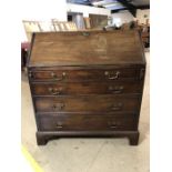 Four drawer bureau with brass handles and drop leaf to reveal inner compartments. With key