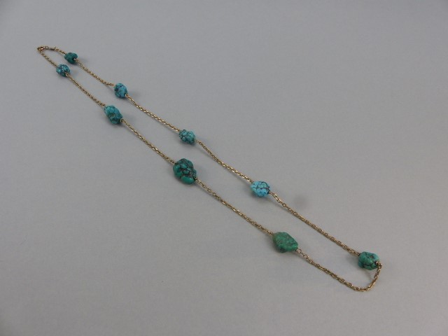 9ct Gold Turquoise Necklace approx: 25” long. The facetted trace link chain is set with 9 natural