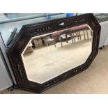 Large octagonal carved wooden framed bevel edged mirror, approx 106cm x 70cm