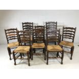 Set of rush-seated ladder back dining chairs - two carvers and six chairs