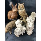 Collection of decorative animal and bird figurines to include ceramic pigs, a begging dog, carved