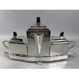 Art Deco style four piece silver plated tea set comprising teapot, milk jug and sugar bowl with