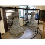 Pair of ballroom style chandeliers on metal frames with glass drops, approx height 100cm