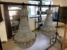 Pair of ballroom style chandeliers on metal frames with glass drops, approx height 100cm