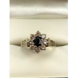 9ct Gold hallmarked Daisy ring set with an oval Sapphire and surrounded by eight Diamonds size 'N'