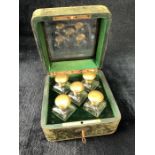 Leather-bound scent bottle travel case containing five scent bottles with green velvet lining, key