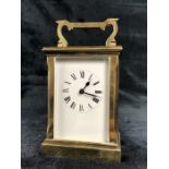 A circa 1900 brass carriage clock, the rectangular face with circular chapter ring set with Roman