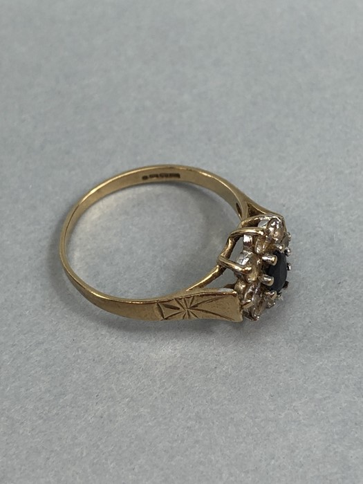 9ct Gold hallmarked Daisy ring set with an oval Sapphire and surrounded by eight Diamonds size 'N' - Image 4 of 5