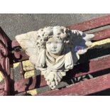 Ornamental wall mounted stone plaque of a cherubs face