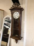 Wooden cased Vienna wall clock with weights and key, white dial and black roman numerals