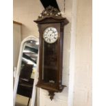 Wooden cased Vienna wall clock with weights and key, white dial and black roman numerals