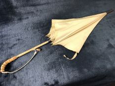 Vintage ivory coloured Paragon umbrella with cane handle and leather strap approx 90cm in length