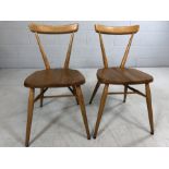 Pair of vintage Ercol blond stacking chairs on tapered legs, approx height 74cm