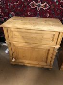 Antique pine cupboard with opening top section and cupboard under, on bun feet