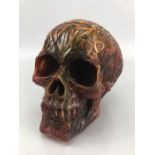 Carved decorative amber-style resin skull approx. 14cm tall.