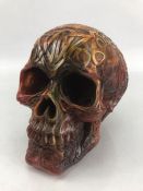 Carved decorative amber-style resin skull approx. 14cm tall.