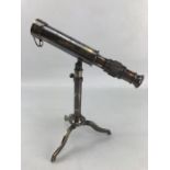 Miniature brass telescope on stand, approx 26cm tall, 23cm in length