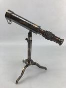 Miniature brass telescope on stand, approx 26cm tall, 23cm in length