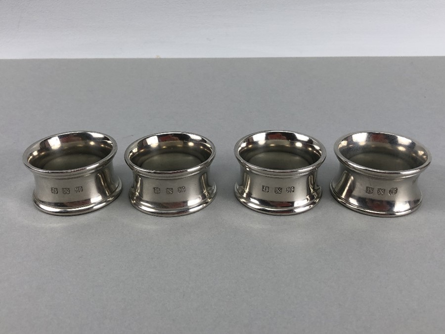 Four matching heavy 255g silver coloured napkin rings the makers marks for John Somers