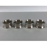 Four matching heavy 255g silver coloured napkin rings the makers marks for John Somers