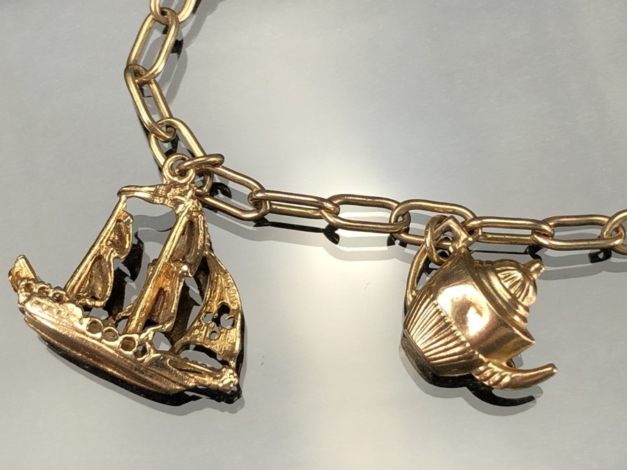 9ct Gold charm bracelet with seven gold charms (the boat marked for 14ct). total weight approx 12. - Image 3 of 5