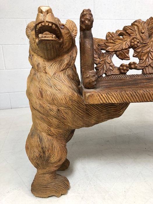 A Black forest style low bench, with two bears flanking a carved back and solid seat, approx 120cm x - Image 5 of 12