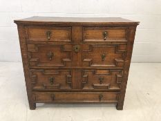 Jacobean chest of five drawers with panelling and brass handles. Approx 93cm x 50cm x 83cm tall