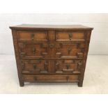 Jacobean chest of five drawers with panelling and brass handles. Approx 93cm x 50cm x 83cm tall