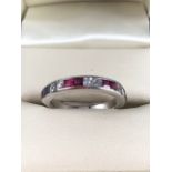 18ct White Gold ring set with Six Square cut Diamonds and 8 Princess cut Rubies, marge 750, size M