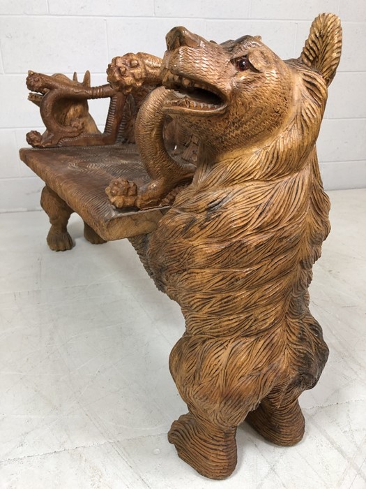 A Black forest style low bench, with two bears flanking a carved back and solid seat, approx 120cm x - Image 9 of 12