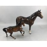 Two Beswick Horse ceramic figurines: one chestnut brown gloss finish, approx. 22cm tall, the other