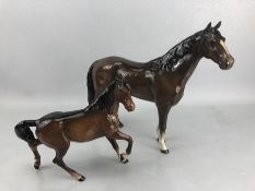 Two Beswick Horse ceramic figurines: one chestnut brown gloss finish, approx. 22cm tall, the other