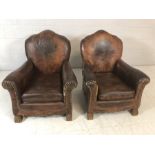 Pair of vintage brown leather armchairs/club chairs with embossed emblem to back, studwork