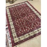 Red ground Kashmir rug with all-over floral pattern and gold border approx. 240cm x 160cm