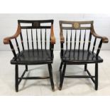 Pair of `Harvard` ebonised elbow chairs with gilt Harvard Veritas seal to splats by Nichols and