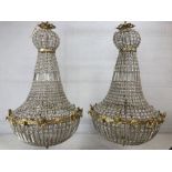 Pair of ballroom style chandeliers on metal frames with glass drops, approx height 100cm