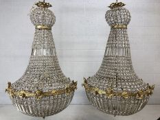 Pair of ballroom style chandeliers on metal frames with glass drops, approx height 100cm