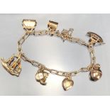 9ct Gold charm bracelet with seven gold charms (the boat marked for 14ct). total weight approx 12.