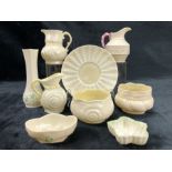 A small collection of Irish Belleek porcelain to include bud vase, two pin dishes, shell pattern