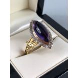 18ct Gold Marquise ring set with an Oval Amethyst stone and surrounded by square cut Diamonds