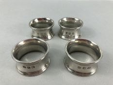 Four matching heavy 245g silver coloured napkin rings the makers marks for John Somers