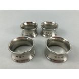 Four matching heavy 245g silver coloured napkin rings the makers marks for John Somers