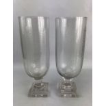 Pair of glass hurricane vases with engraved leaf design, approx 34cm in height