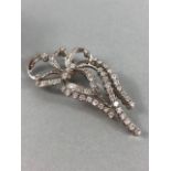 18ct White Gold Brooch in a ribbon style set with in excess of 50 diamonds